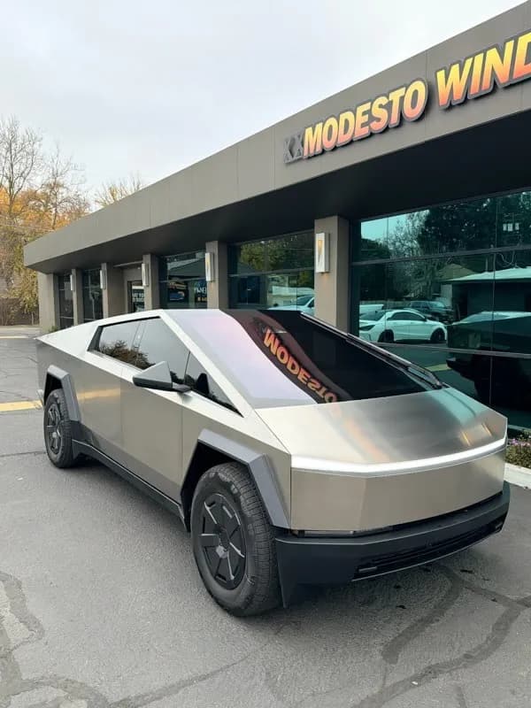 Bronze Tesla Cybertruck with professional window tinting at Modesto Window Tint storefront
