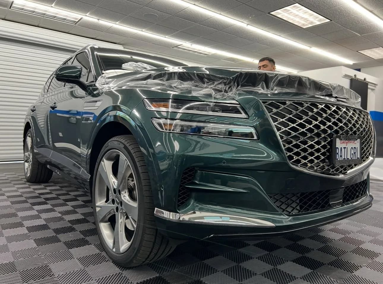 Genesis luxury SUV receiving professional paint protection film installation