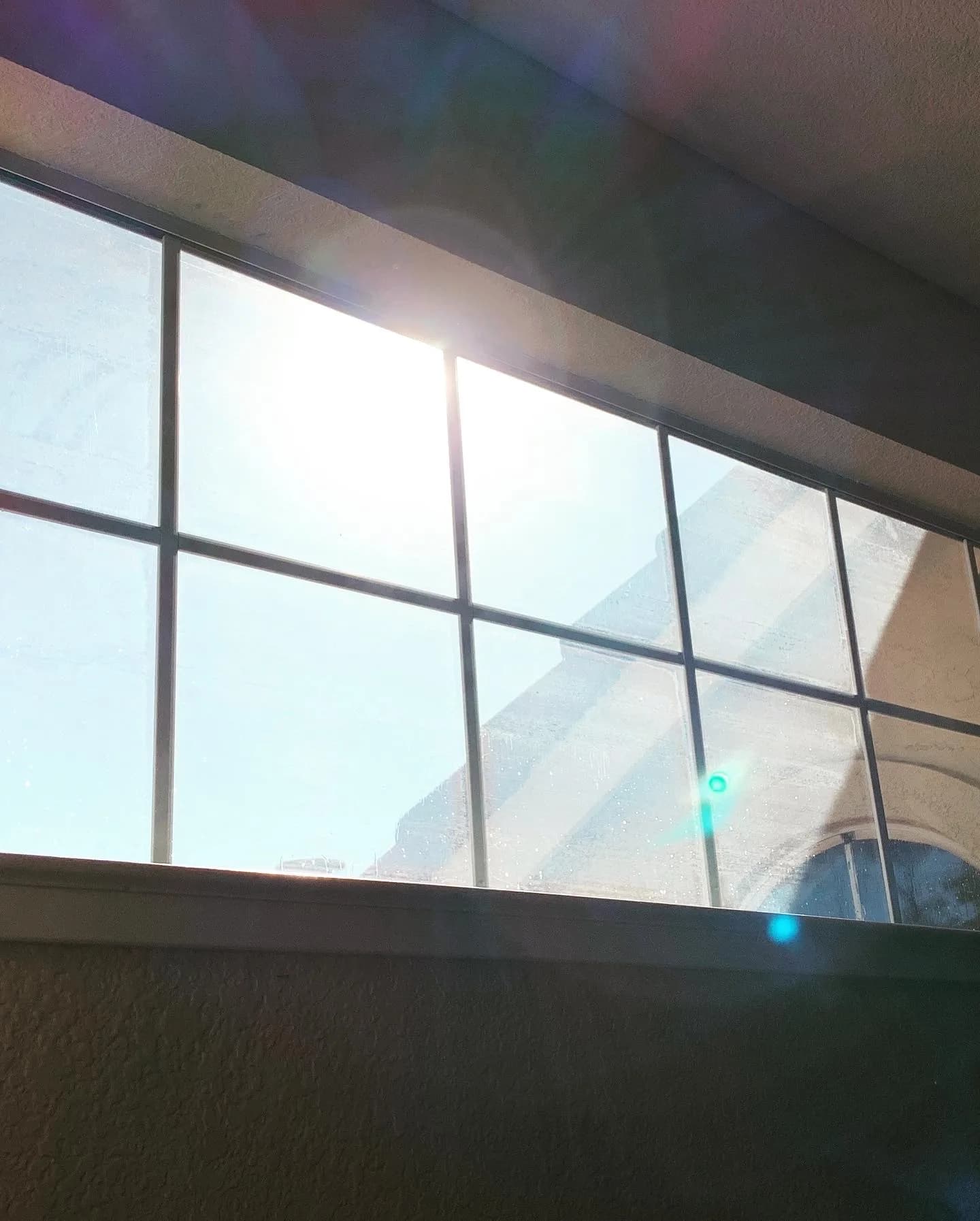 Glass curtain wall of a Modesto commercial building seen from below