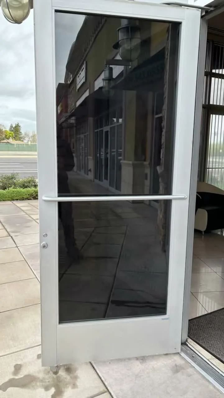 Smileworld Dental storefront in Modesto with window film on the entry and frontage glazing