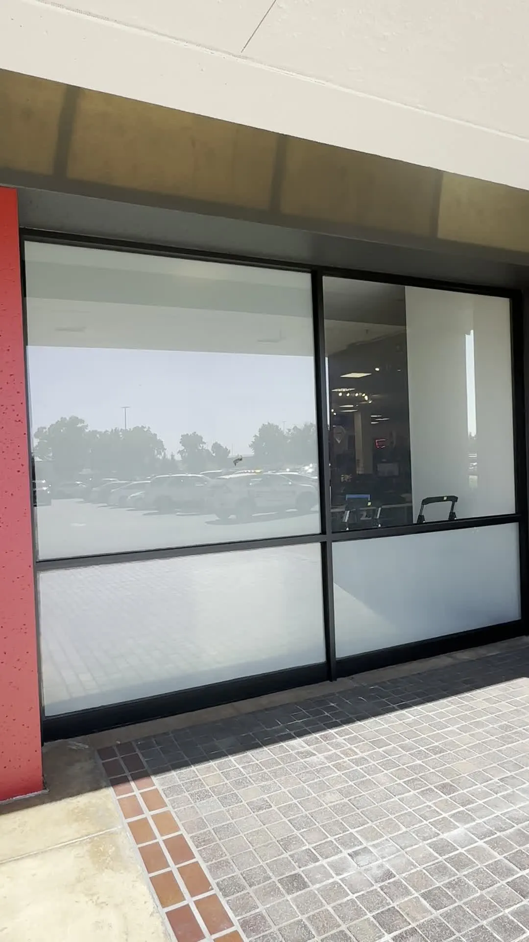 Interior glass partition with frosted film for office privacy