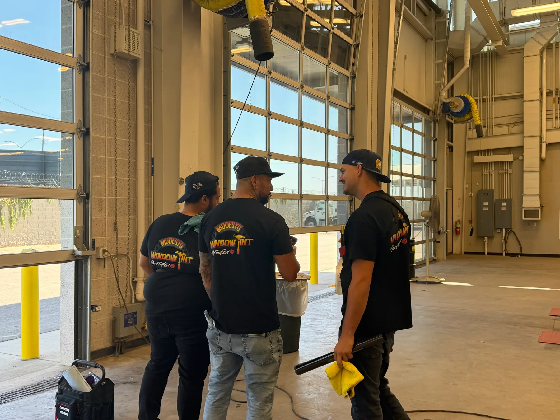 Modesto Window Tint installers inside a vehicle bay at Stanislaus County Public Works