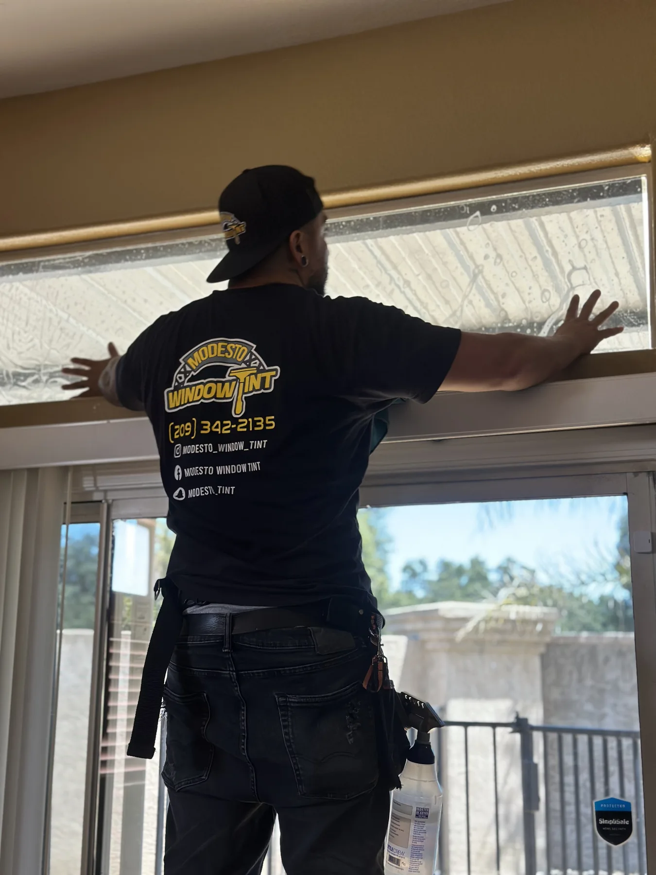 Modesto Window Tint installer fitting residential window film in a home