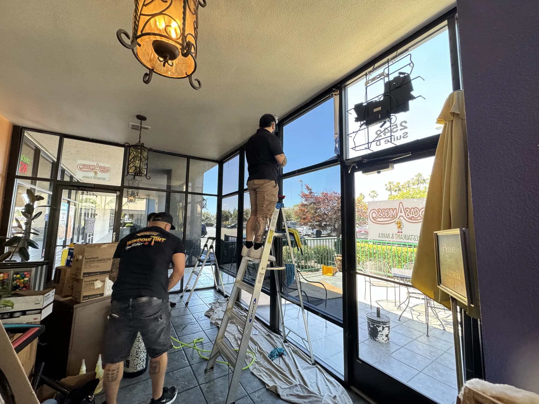 Installers applying solar control window film at Casa Amigos restaurant in Modesto