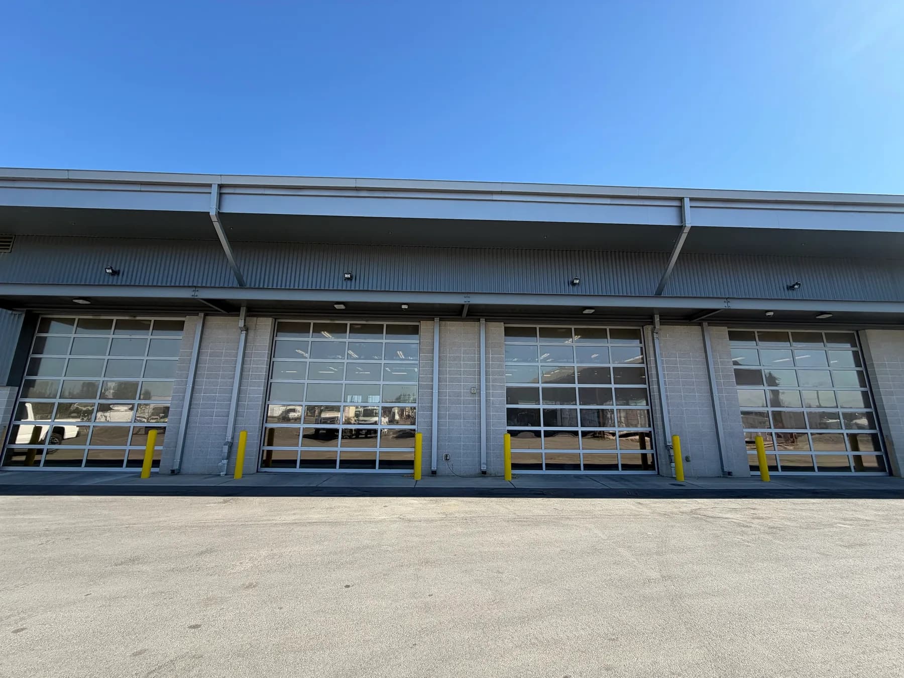 Four full-view glass bay doors with window film at the Stanislaus County Public Works facility in Modesto